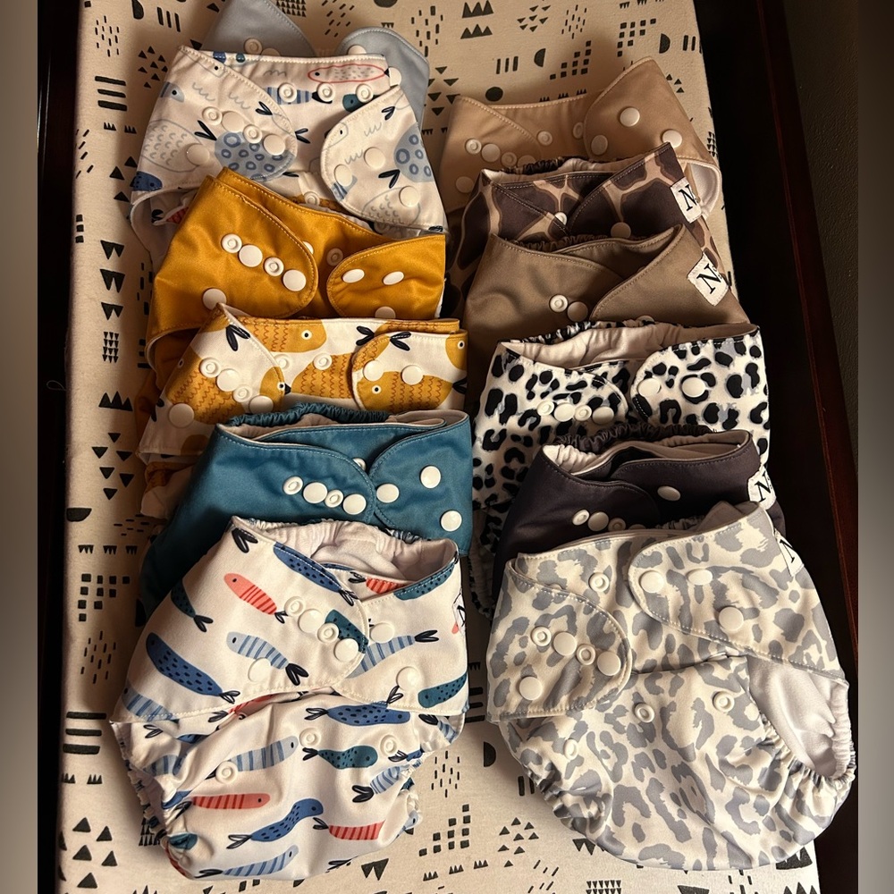 A dozen Nora's Nursey pocket diapers with bamboo inserts.